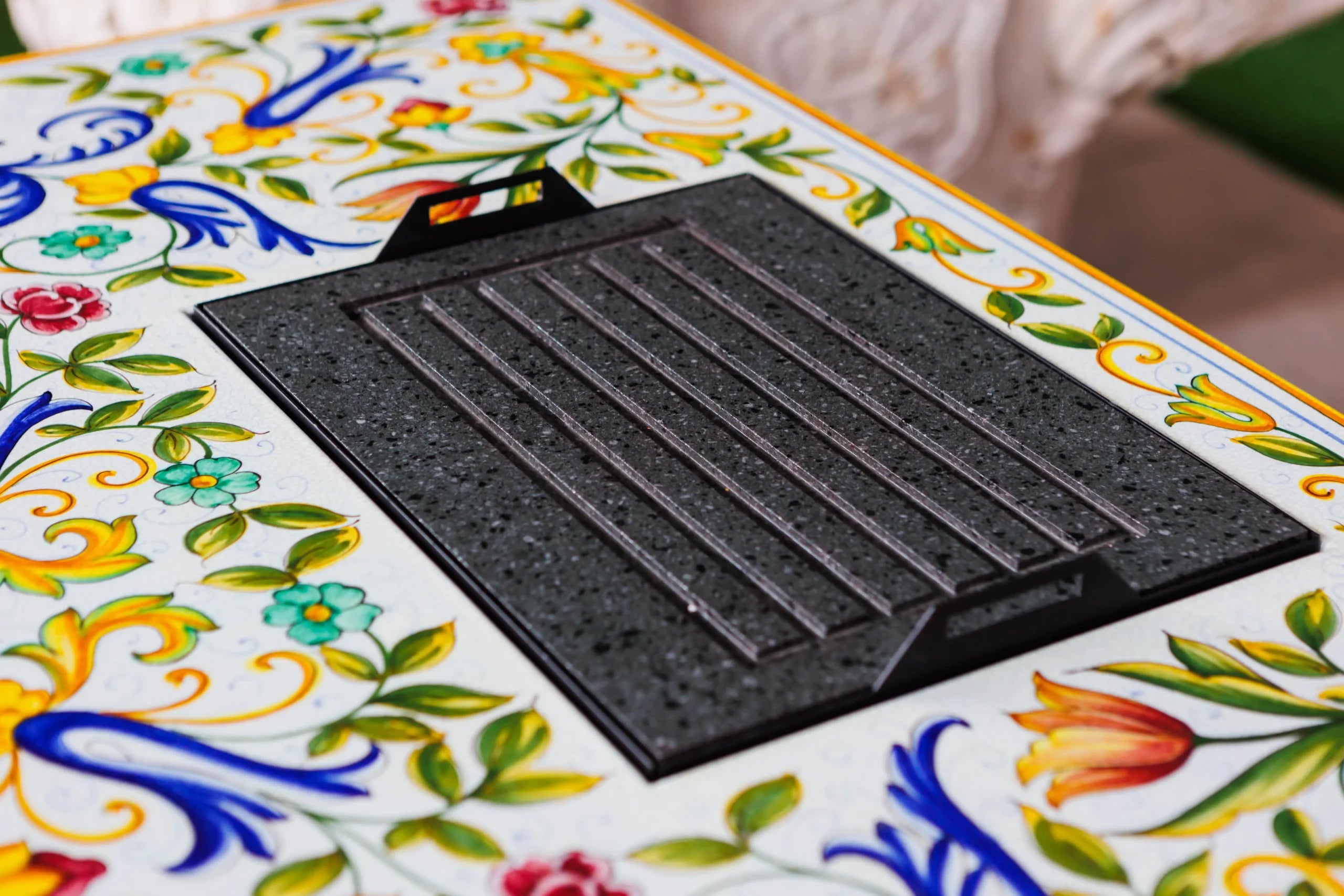 Black grill mat on a colorful ceramic surface