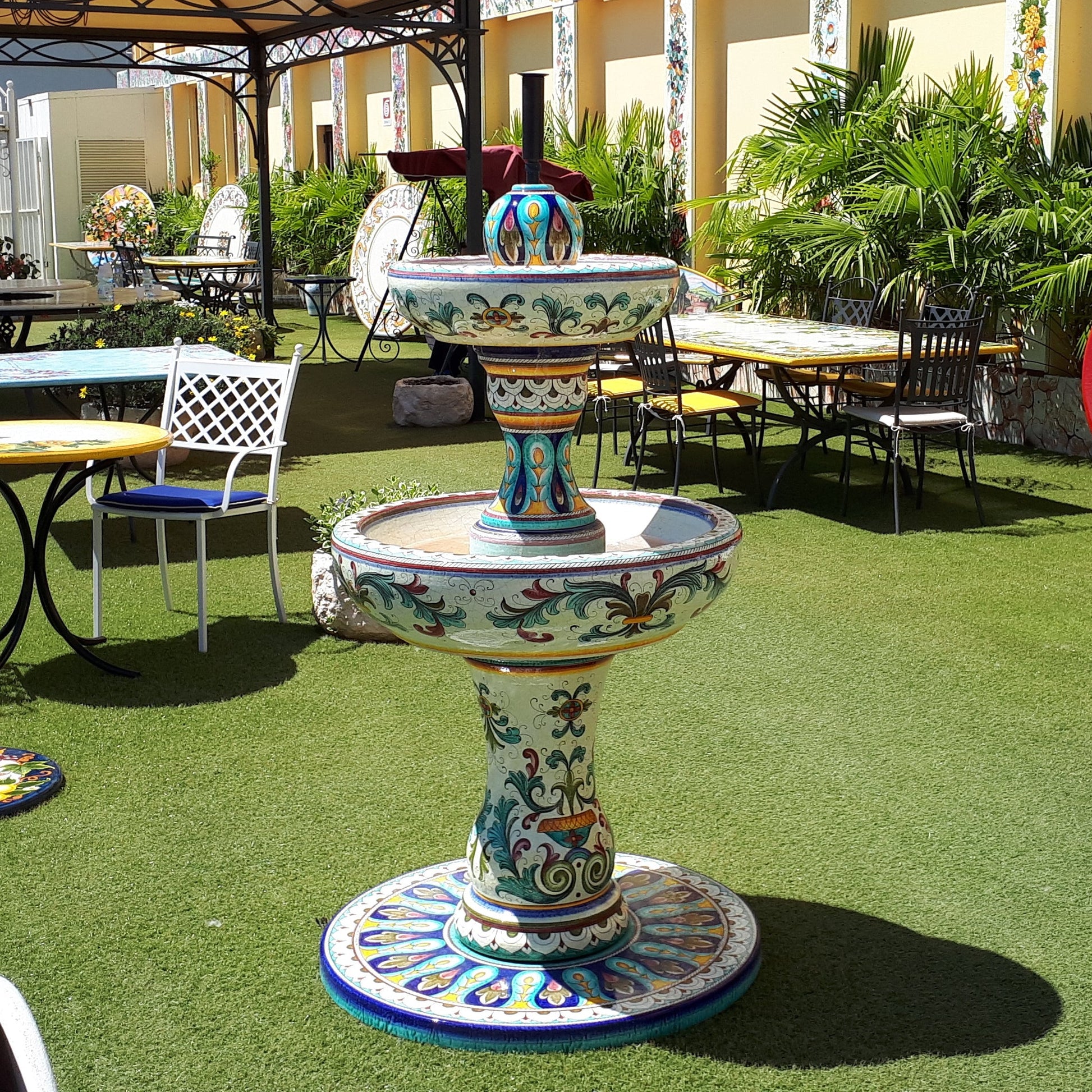 Decorative outdoor fountain with colorful design in a garden setting