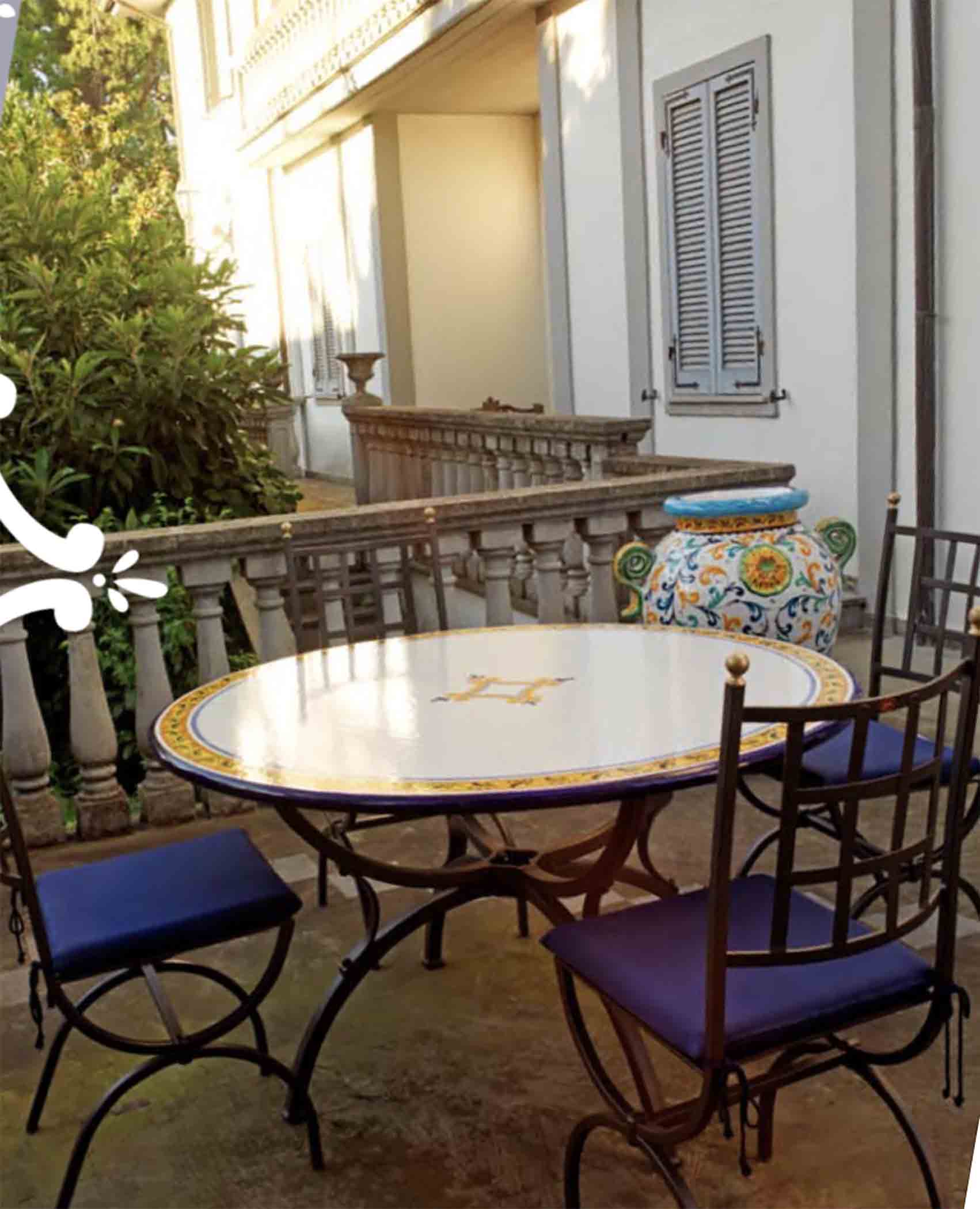 Italian hand-painted ceramic glazed round volcanic stone table in Palermo Classico geometric border design with a classic wrought iron base