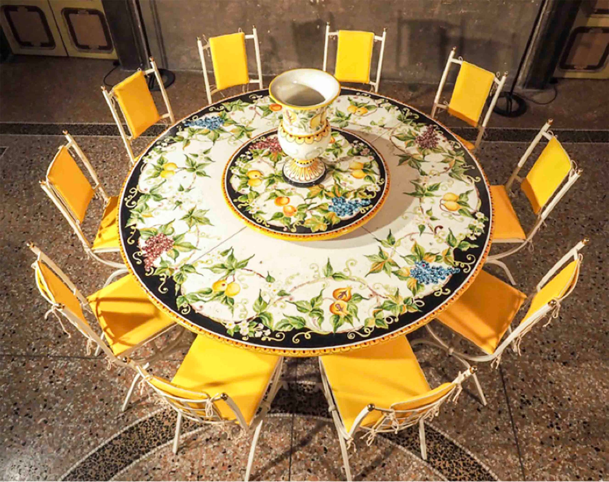 Grand scale Italian hand-painted ceramic glazed round volcanic stone table in Sorrento Gran Frutteto mixed fruit design with a wrought iron base and dining chairs