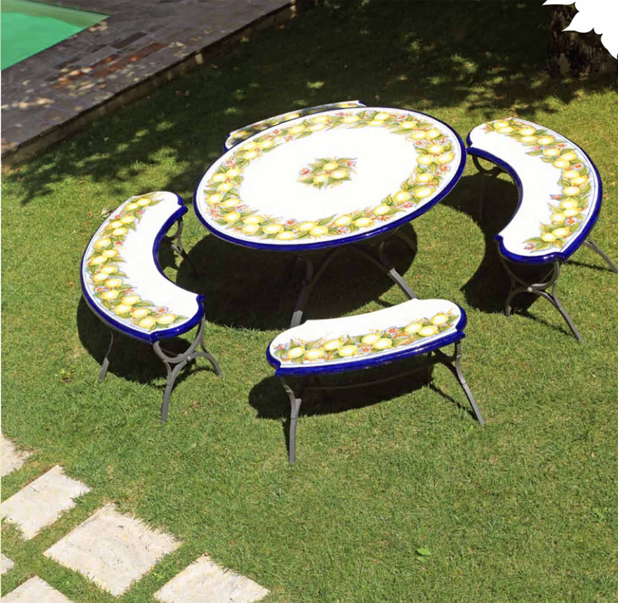 Italian hand-painted ceramic glazed round volcanic stone table and matching curved benches in Sorrento Limoneto design on a luxury garden