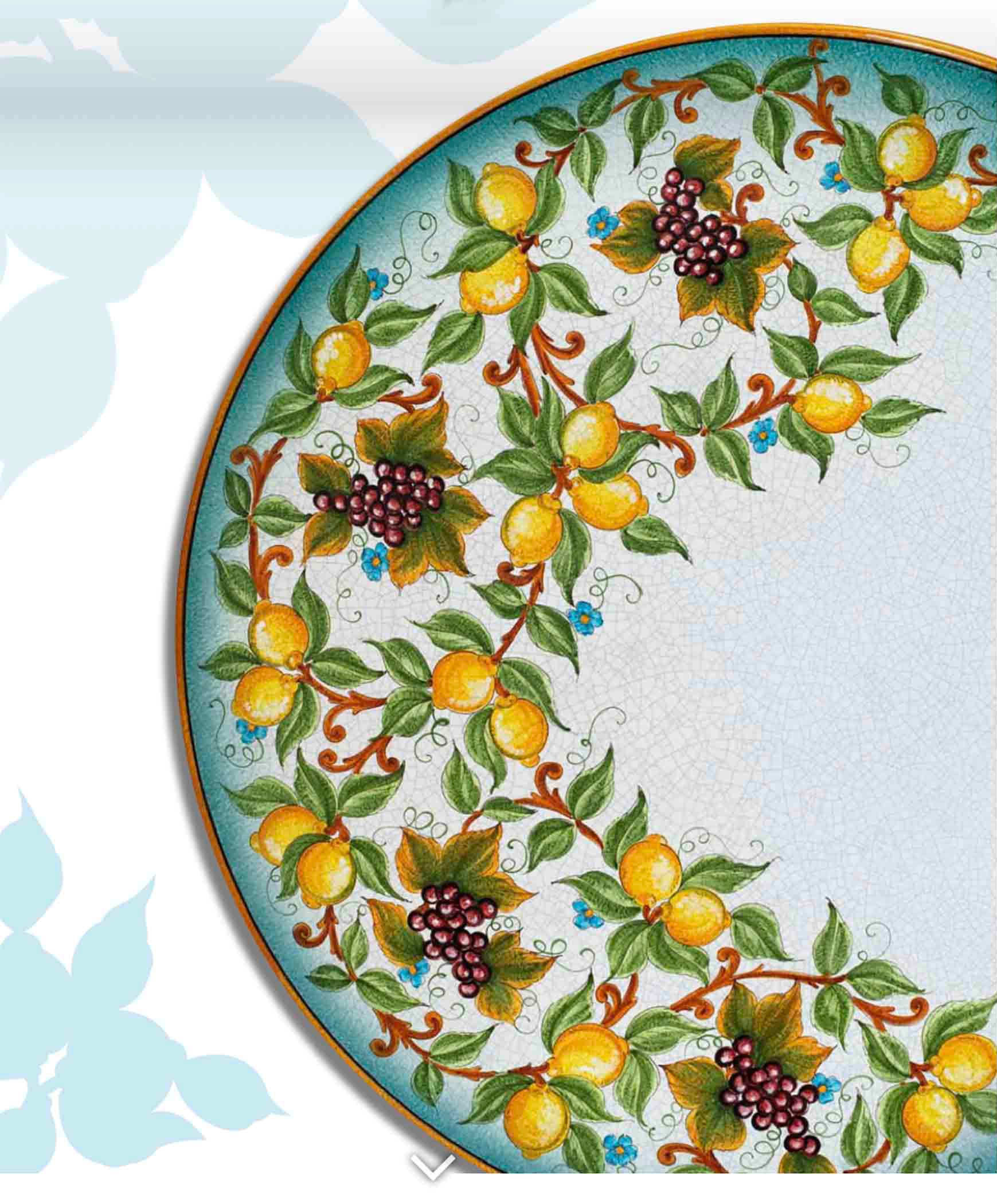 Close up detail of the open ivory crackle background glaze and vibrant turquoise airbrushed border on the Riviera round volcanic stone table
