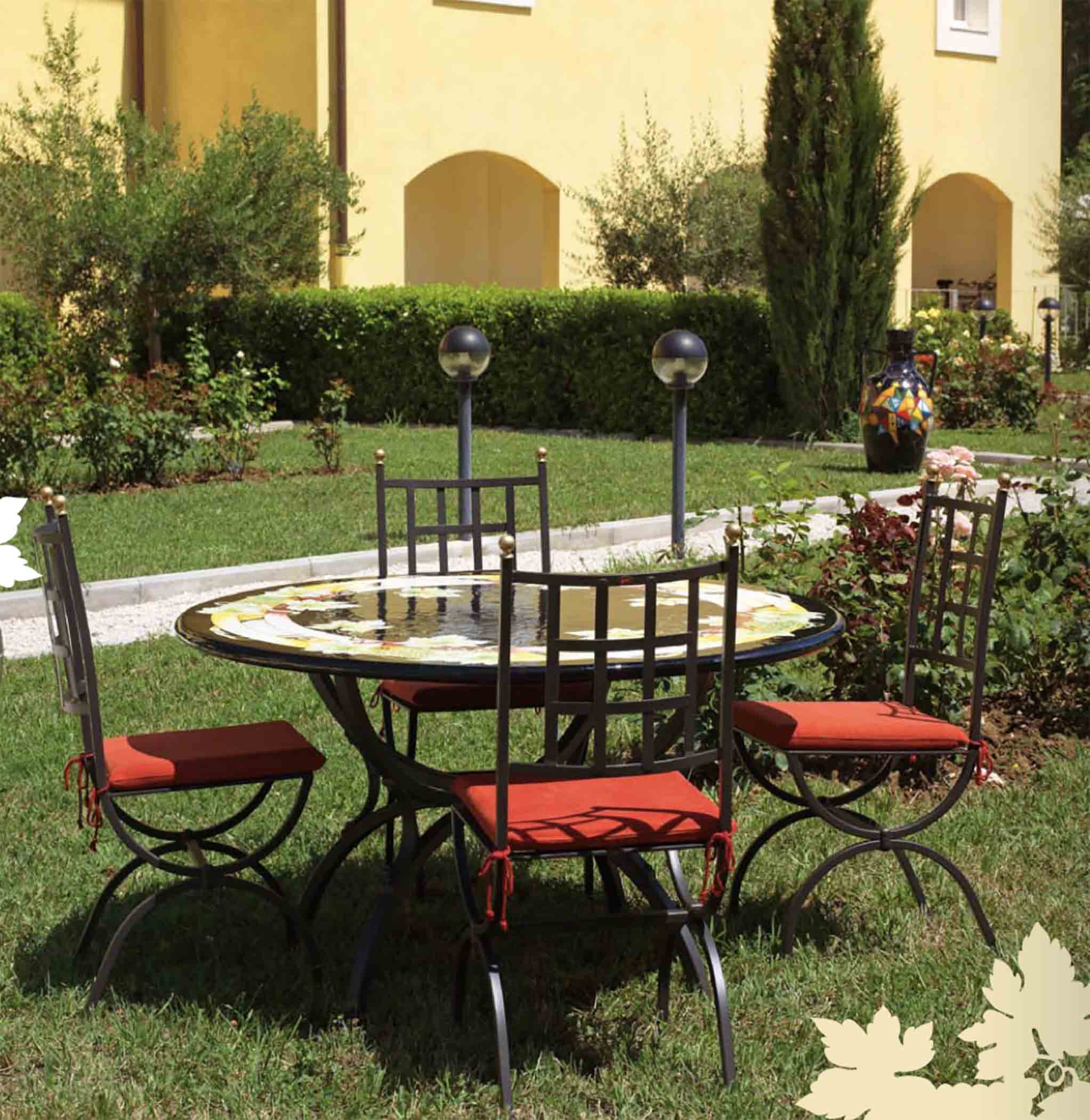 Italian hand-painted ceramic glazed round volcanic stone table in Chianti Vigneto green grape and black center design with a classic wrought iron base