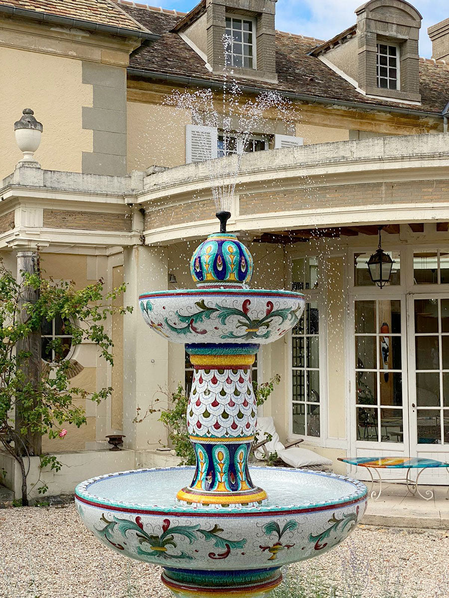 Decorative fountain in front of a large building with classical architecture