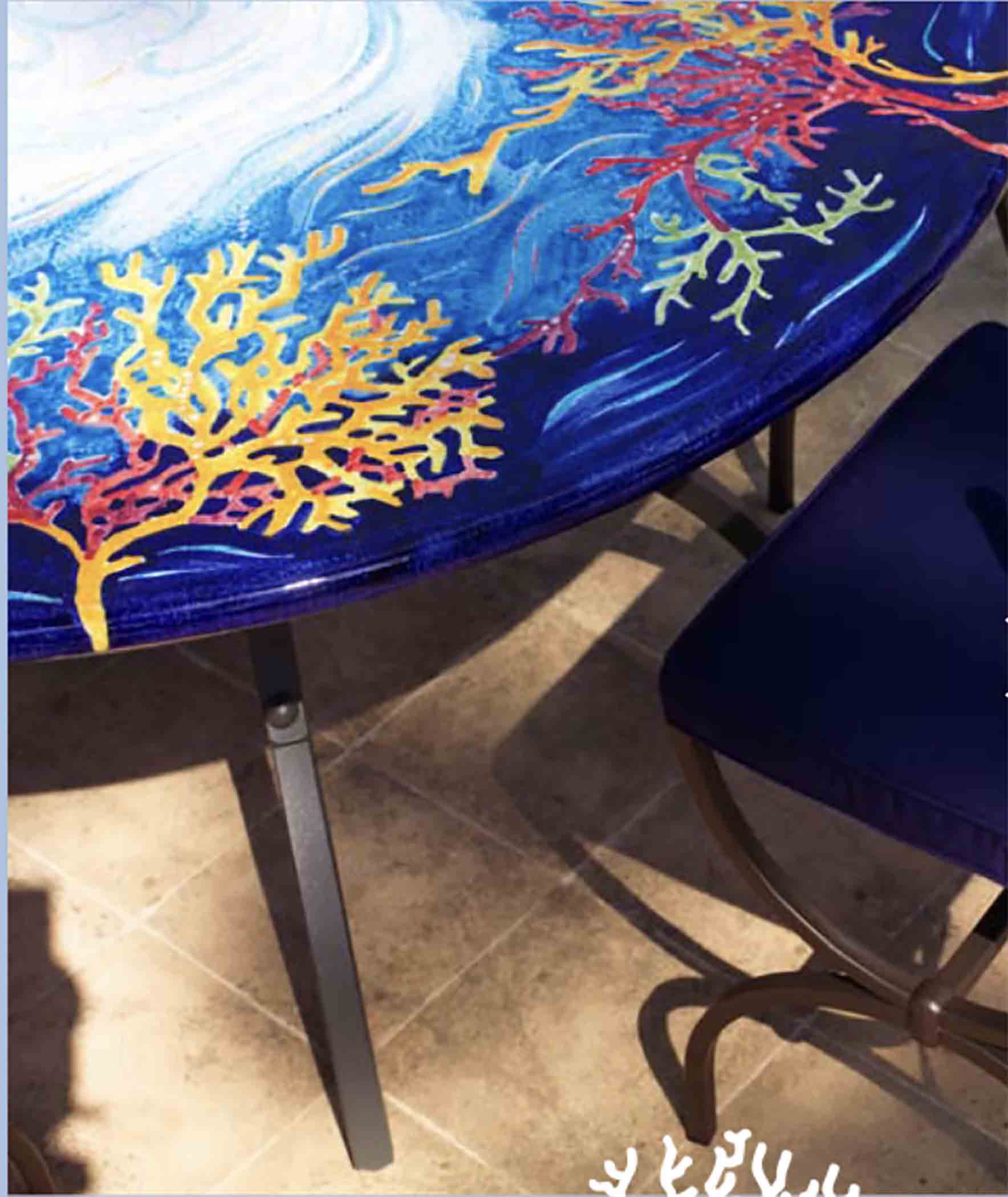 Side profile showing the smooth deep blue edge finish and custom thickness choices of a glazed round volcanic stone table top
