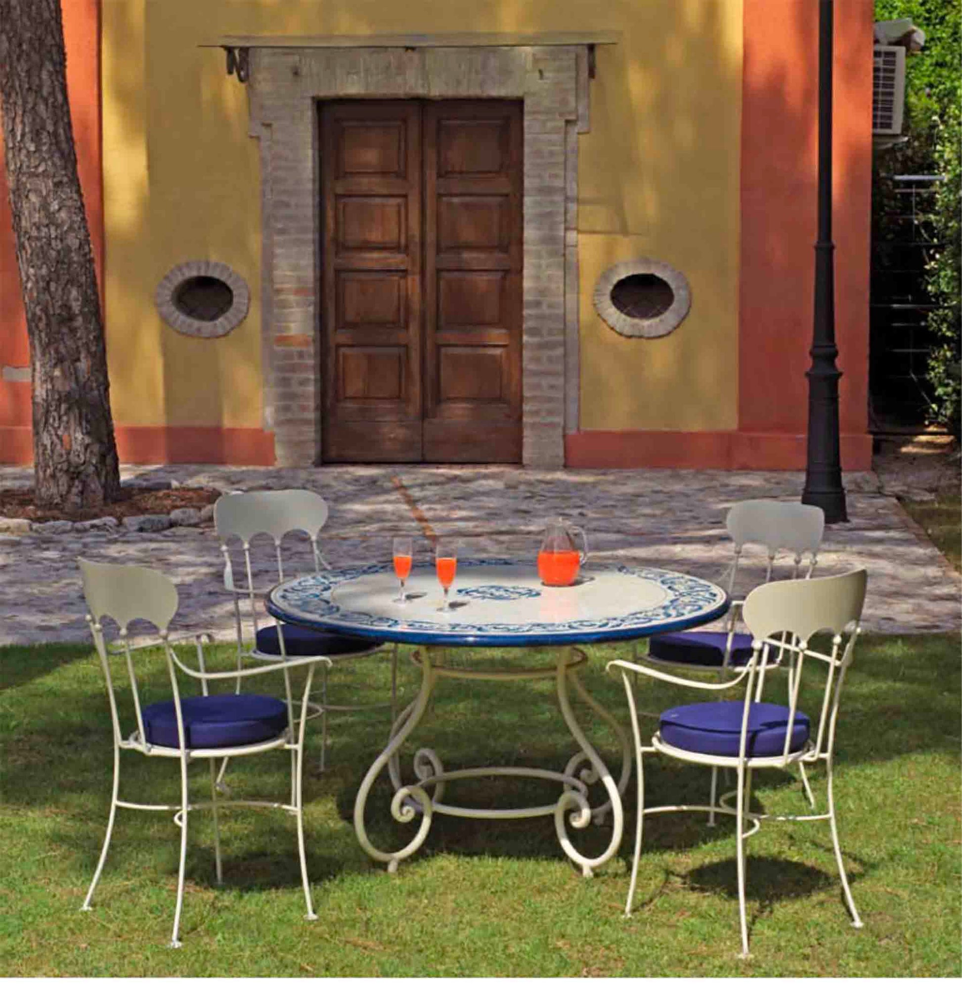 Italian hand-painted ceramic glazed round volcanic stone table in Portofino Azzurro blue scrollwork design with a classic wrought iron base